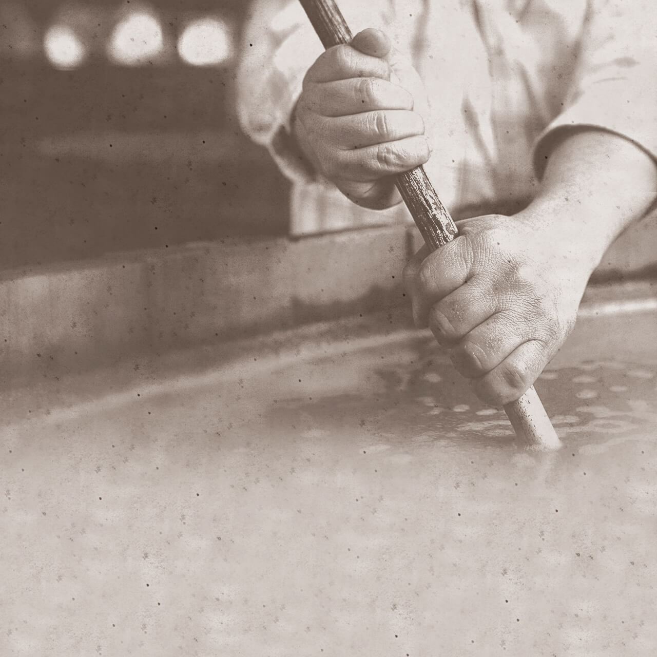 A distiller is creating the "Sour Mash process".