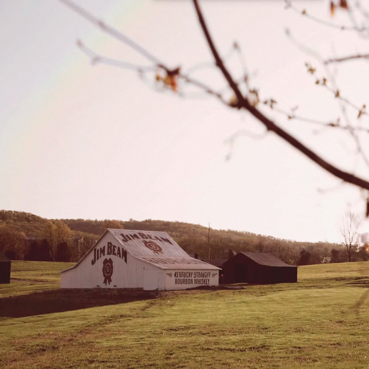 The Jim Beam American Stillhouse surrounded by beautiful Kentucky landscape.