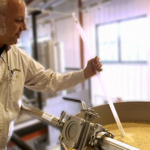 Distiller checks the fermentation process of Jim Beam.