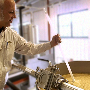 A Jim Beam® worker checking on the fermentation process